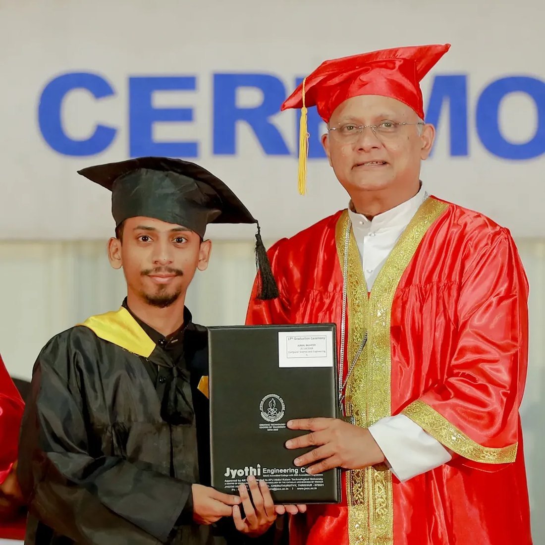 Ajmal Basheer in graduation cap and gown receiving his B.Tech degree folder from Jyothi Engineering College on stage at the graduation ceremony