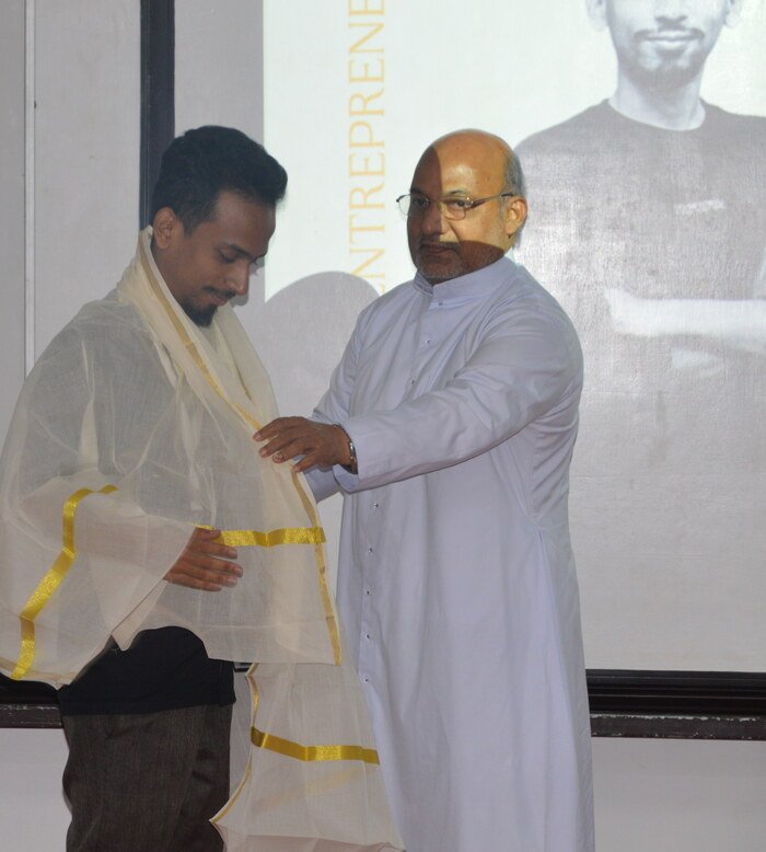 Ajmal Basheer receiving recognition from his college as its youngest entrepreneur