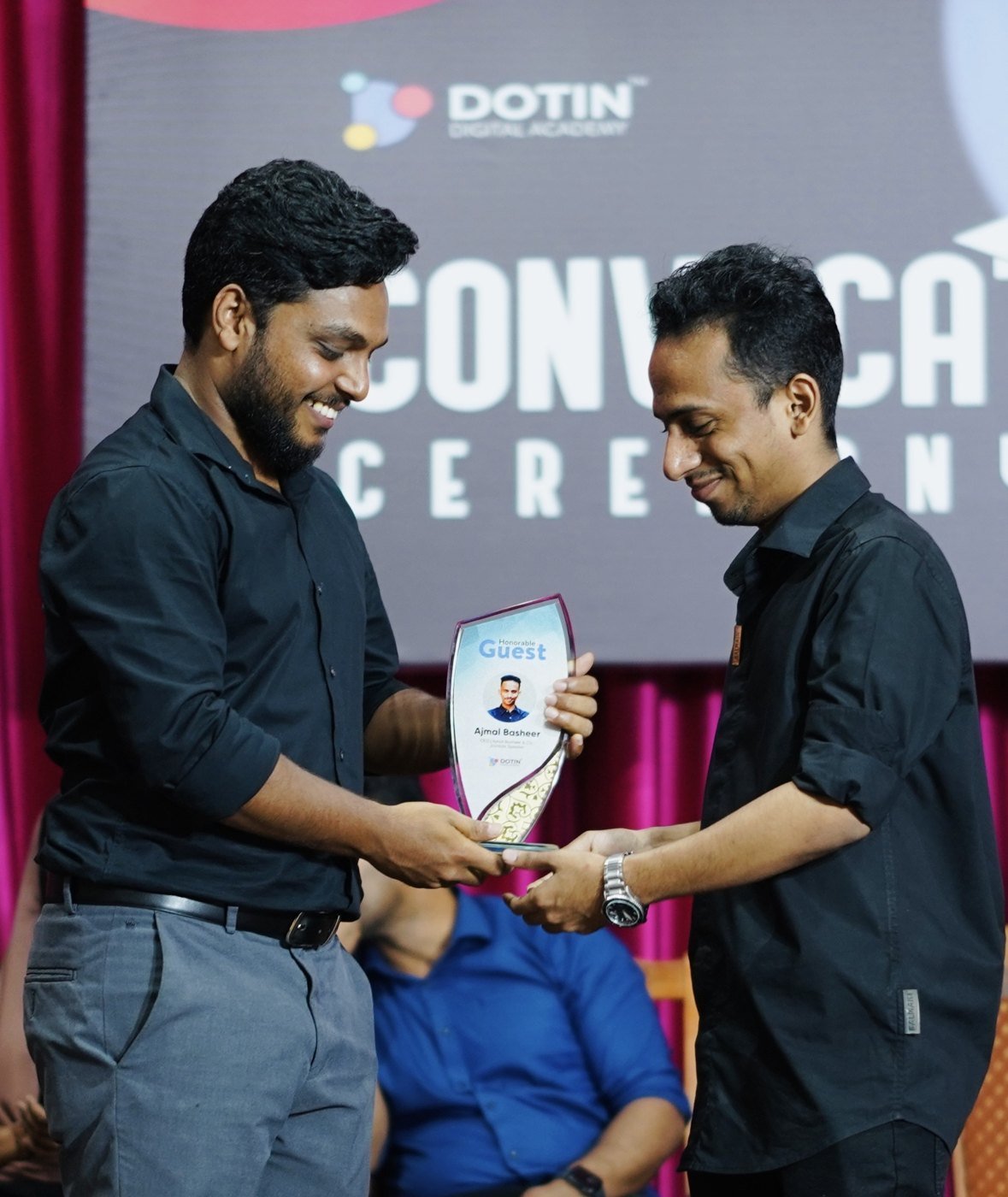 Ajmal Basheer receiving an Honorable Guest trophy on stage at Dotin Digital Academy's convocation ceremony